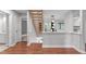 Modern staircase with wood treads and dark floors, bright with lots of light at 7116 Asheway Dr, Holly Springs, NC 27540