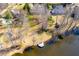 A beautiful waterfront property featuring a private wooden dock and mature trees in a lake community at 7516 Orchard Crest Ct, Apex, NC 27539