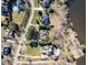 A picturesque aerial view of lakefront homes showcasing lush landscaping and neighborhood street layouts at 7516 Orchard Crest Ct, Apex, NC 27539