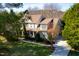 Aerial view of a stately home with a large lot, mature trees, and a well-maintained lawn at 7516 Orchard Crest Ct, Apex, NC 27539