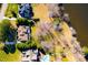 Aerial view of property with lake frontage, lush landscaping and patio at 7516 Orchard Crest Ct, Apex, NC 27539