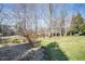 A sprawling backyard with mature trees, landscaping and an iron fence at 7516 Orchard Crest Ct, Apex, NC 27539