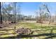 Large backyard with fire pit and lake view, perfect for outdoor entertaining at 7516 Orchard Crest Ct, Apex, NC 27539