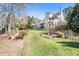 A beautifully landscaped backyard with lush green grass and mature trees at 7516 Orchard Crest Ct, Apex, NC 27539