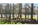 Scenic backyard view with mature trees and lake at 7516 Orchard Crest Ct, Apex, NC 27539
