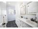 Bright bathroom with double vanity, marble countertop, and tiled floors and wall at 7516 Orchard Crest Ct, Apex, NC 27539