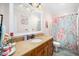 Cozy bathroom with a floral shower curtain, vanity, and a large mirror at 7516 Orchard Crest Ct, Apex, NC 27539