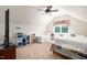 A bright bedroom with two twin beds, a ceiling fan, and a dormer window at 7516 Orchard Crest Ct, Apex, NC 27539