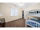 Bright bedroom featuring a white bunk bed, ceiling fan and a view of a closet at 7516 Orchard Crest Ct, Apex, NC 27539