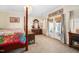 Cozy bedroom features a four-poster bed, decorative fireplace, and access to the outdoors at 7516 Orchard Crest Ct, Apex, NC 27539