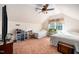A bright bedroom with two twin beds, a ceiling fan, and a dormer window at 7516 Orchard Crest Ct, Apex, NC 27539