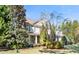 Charming two-story home with stone accents, covered porch, and professionally landscaped yard at 7516 Orchard Crest Ct, Apex, NC 27539