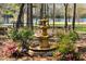 Beautiful fountain surrounded by pink flowers and greenery at 7516 Orchard Crest Ct, Apex, NC 27539