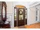 Welcoming foyer with hardwood floors, decorative trim, and a beautiful entry door at 7516 Orchard Crest Ct, Apex, NC 27539