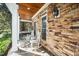 Inviting front porch with stone accents, rocking chairs, and a cozy swing for relaxation at 7516 Orchard Crest Ct, Apex, NC 27539