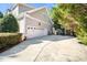 Spacious two-car garage with ample parking and a basketball hoop for outdoor fun at 7516 Orchard Crest Ct, Apex, NC 27539