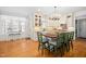 Bright kitchen features an island with barstool seating, white cabinetry and a window view at 7516 Orchard Crest Ct, Apex, NC 27539