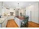 Spacious kitchen with a large island, white cabinets, stainless steel appliances, and a chandelier at 7516 Orchard Crest Ct, Apex, NC 27539