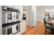 Modern kitchen featuring stainless steel ovens, granite countertops, and ample cabinet space at 7516 Orchard Crest Ct, Apex, NC 27539