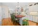 Spacious kitchen with an island, white cabinetry, stainless steel appliances, and hardwood floors at 7516 Orchard Crest Ct, Apex, NC 27539
