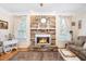 Elegant living room showcasing a stone fireplace and large windows at 7516 Orchard Crest Ct, Apex, NC 27539