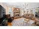 Cozy living room with stone fireplace, hardwood floors, and comfortable seating arrangement at 7516 Orchard Crest Ct, Apex, NC 27539