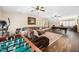 Spacious living room with hardwood floors, a pool table and comfortable seating at 7516 Orchard Crest Ct, Apex, NC 27539