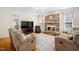 Inviting living room with stone fireplace, hardwood floors and an elegant chandelier at 7516 Orchard Crest Ct, Apex, NC 27539