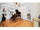 The music room features a grand piano, custom built-in shelving, and beautiful hardwood floors at 7516 Orchard Crest Ct, Apex, NC 27539