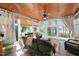 Charming sunroom with a wood ceiling, wicker furniture, and large windows at 7516 Orchard Crest Ct, Apex, NC 27539