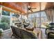 Cozy sunroom with tile flooring and views of the backyard and lake at 7516 Orchard Crest Ct, Apex, NC 27539