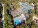 Aerial view showcases tennis courts, a sparkling pool, and clubhouse amidst a verdant, landscaped setting at 81008 Alexander, Chapel Hill, NC 27517