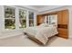 Bright bedroom featuring built-in storage, mirrored headboard, and large windows with a lush view at 81008 Alexander, Chapel Hill, NC 27517