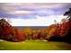 Expansive golf course with rolling green hills, mature trees showcasing fall colors under a cloudy sky at 81008 Alexander, Chapel Hill, NC 27517