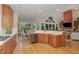 Open kitchen with stainless steel appliances, wood cabinets and lots of counter space connects to a dining area and a living room at 81008 Alexander, Chapel Hill, NC 27517
