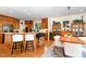 Eat-in kitchen features wooden cabinets, modern appliances, and seating at the breakfast bar for casual dining and entertaining at 81008 Alexander, Chapel Hill, NC 27517