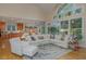 Bright living room features large windows, a vaulted ceiling, and an open floor plan with access to the kitchen and dining area at 81008 Alexander, Chapel Hill, NC 27517