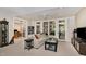 This living room features a ceiling fan, multiple doors to the outside, and is open to the basement at 81008 Alexander, Chapel Hill, NC 27517