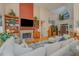 Cozy living room with fireplace, built-in bookshelves, and high ceilings provides a comfortable space for relaxation and entertainment at 81008 Alexander, Chapel Hill, NC 27517