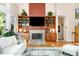 Living room with fireplace, built-in bookshelves, and a wall-mounted TV provides a cozy and functional space for relaxation at 81008 Alexander, Chapel Hill, NC 27517