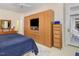 This main bedroom features a large integrated wooden dresser, carpeted floors, and a door to the outside patio at 81008 Alexander, Chapel Hill, NC 27517