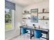 Well-lit office space with two desks, blue chairs, and stylish decor at 813 Ottawa Dr, Garner, NC 27529