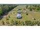 Expansive aerial view of a home featuring a metal roof, fenced yard, and a shed on a spacious lot at 8163 Julian Rd, Dunn, NC 28334