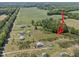 Aerial view showcasing land parcel, featuring wooded areas and nearby residences in a serene location at 8163 Julian Rd, Dunn, NC 28334