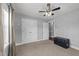 Light and airy bedroom featuring carpeted floors, a ceiling fan, large closet, and a decorative trunk at 8163 Julian Rd, Dunn, NC 28334