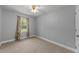 Cozy bedroom boasts soft carpet, a ceiling fan, a single window with view, and neutral walls at 8163 Julian Rd, Dunn, NC 28334