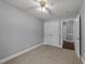 Bright bedroom with carpet, a ceiling fan, access to another room, and a closet at 8163 Julian Rd, Dunn, NC 28334