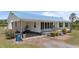 Exterior of a house with metal roof, black shutters and potted plants at 8163 Julian Rd, Dunn, NC 28334