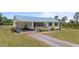 Charming exterior featuring metal roof, black shutters and landscaping at 8163 Julian Rd, Dunn, NC 28334