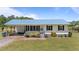 Charming single-story home featuring a metal roof, covered porch, and well-manicured lawn at 8163 Julian Rd, Dunn, NC 28334